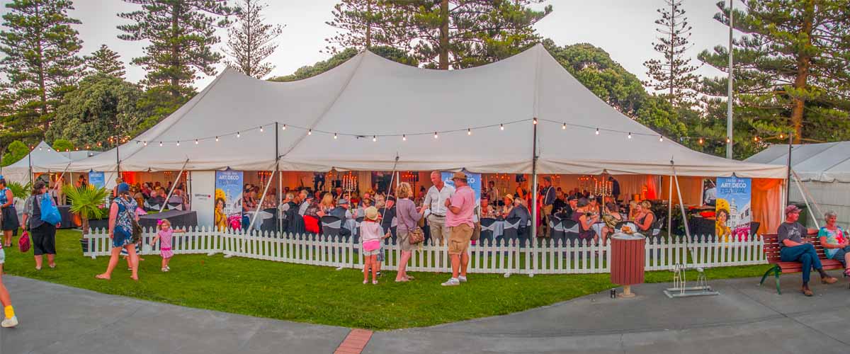 Art Deco Festival marquee open on one side to enjoy buffet dinner, music and the sea views