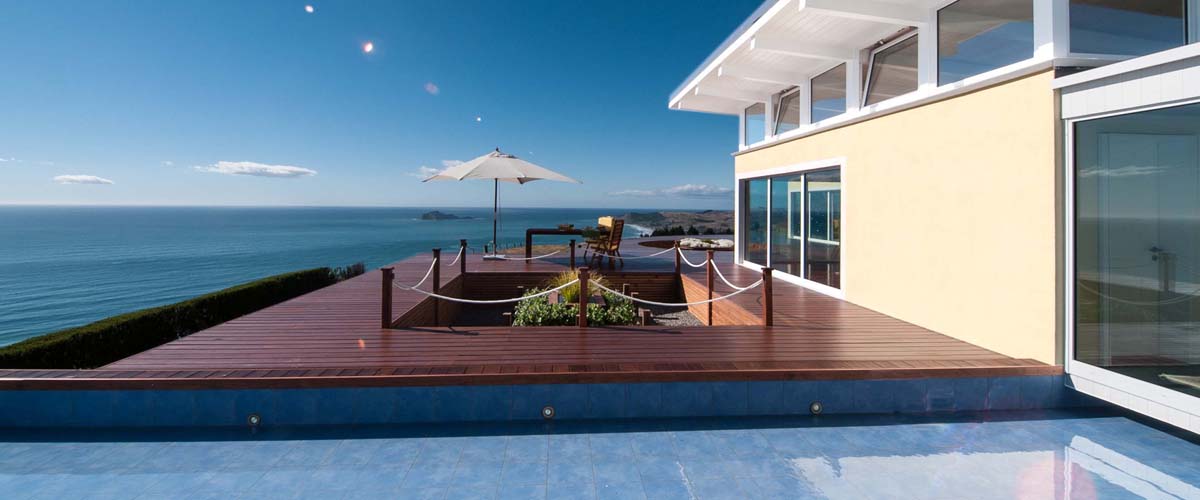 Best ocean-view accommodation with breakfast table on the deck with uninterrupted view. Link over the water features which separates the guest house