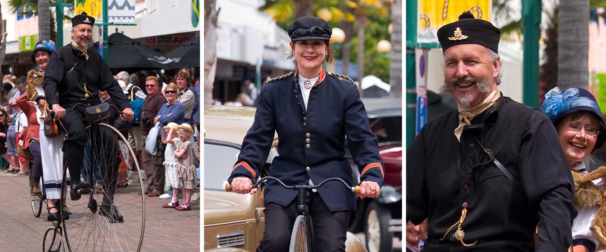 Cheerful locals ride vintage bicycles dressed in costumes matching the Art Deco time era.
